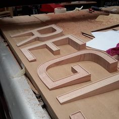 the letters are made out of wood and ready to be carved into something that looks like it is being worked on