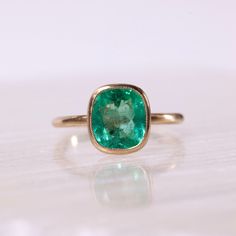 2.38ct Colombian emerald set in solid 14k recycled gold. Antique inspired designs with a brushed finish and minimal milgrain detail around the bezel. This ring would be stunning as an engagement ring or worn as an everyday right hand ring. This ring is currently a size 6 and eligible for a complimentary resize. Once resized, this ring is non-refundable and not eligible for return. If you would like to resize this ring from a size 6, please select your ring size in the drop down menu. Allow 2-3 weeks for processing. Timeless Bezel-set Emerald Ring For May Birthstone, Timeless Bezel Set Emerald Ring For May Birthstone, Timeless Emerald Ring With Bezel Setting For May Birthstone, Timeless May Birthstone Emerald Ring With Bezel Setting, Classic Emerald Ring With Smooth Bezel For Anniversary, Timeless Emerald Rings With Bezel Setting, Classic Yellow Gold Emerald Ring With Smooth Bezel, Classic Green Ring With Smooth Bezel, Classic Everyday Emerald Solitaire Ring