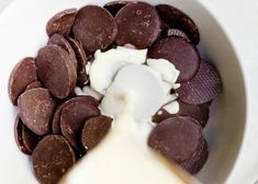 a white bowl filled with chocolate chips and cream