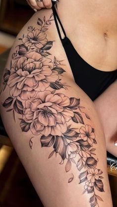 a woman's thigh with flowers on it