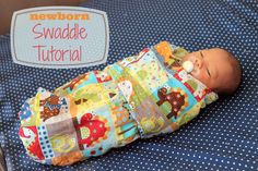 a baby laying on top of a bed next to a sign that says newborn swaddle