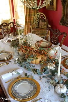 a dining room table set for thanksgiving dinner