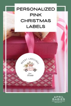 personalized pink christmas labels on stacked boxes with ribbon and bow around the edges for gifting