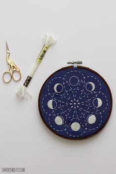 an embroidery project with scissors and thread