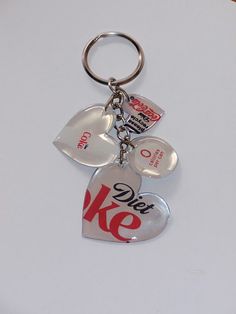 a keychain with two heart shaped tags attached to it's sides and the words we love ke