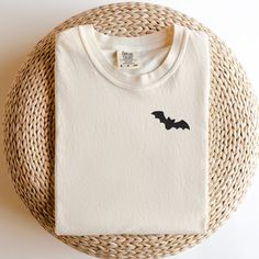 Add a touch of eerie elegance to your Halloween wardrobe with our exquisite Embroidered Bat Halloween T-Shirt. Crafted with attention to detail and a hint of spookiness, this shirt is the perfect blend of style and Halloween spirit. Whether you're heading to a costume party or just want to show off your festive side, this t-shirt is a must-have addition to your collection. Product Details: Design: A stunningly detailed bat embroidery that captures the mystique of the night. The intricate stitching brings out the bat's intricate wings and features, creating a captivating visual. Material: Premium quality cotton ensures comfort and durability, making this t-shirt perfect for extended wear throughout the Halloween season and beyond. Fit: A relaxed and comfortable fit suitable for all body typ Halloween Embroidered Long Sleeve T-shirt, Halloween Long Sleeve Embroidered T-shirt, Halloween Embroidered Cotton Tops, Halloween Cotton Embroidered Tops, Embroidered Long Sleeve T-shirt For Halloween, Embroidered Cotton Tops For Halloween, Halloween Embroidered Crew Neck T-shirt, Bat Top, Bat Embroidery