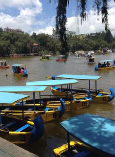 several small boats floating on top of a river