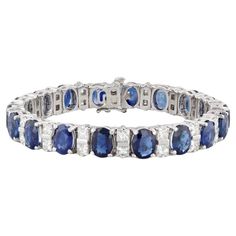 This stunning custom bracelet is set with deep blue oval sapphires accented by VS2 princess diamonds, creating a lovely white and blue contrast along a polished platinum chain. This statement piece displays the highest craftsmanship and comes with a GIA certificate for the sapphires as well as with an inner black velveteen box and outer white box. Gemstone Information: - Natural Sapphires - Total Carats - 29ctw Cut - Oval Brilliant Color - Blue Treatment - Heated GIA#: 1226436814 Geographic Orig Blue Sapphire Bracelet, Platinum Chain, Diamond Bracelet Design, Gia Certificate, Ceylon Blue Sapphire, Custom Bracelet, Bracelet Design, Sapphire Bracelet, Princess Diamond