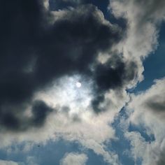 the sun is shining through some clouds in the sky