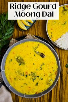 two bowls filled with yellow food next to rice and lemon wedges on a wooden table