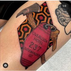 a tattoo on the leg of a person with a hammer and blood bag in it