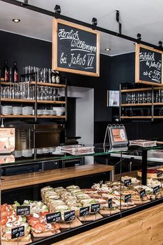 a display case in a restaurant filled with lots of food and drinks on the shelves