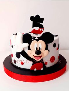 a mickey mouse birthday cake with the number five on it's top and polka dots