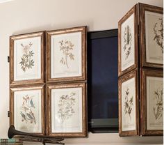 a fireplace with four framed pictures on the mantle