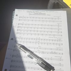 a pen sitting on top of sheet music