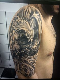 a man's half sleeve with an eagle tattoo on his left arm and chest