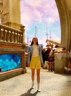 a woman standing in front of an aquarium