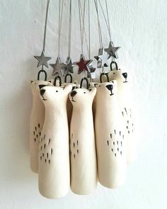 four ceramic bears hanging from strings with stars on them