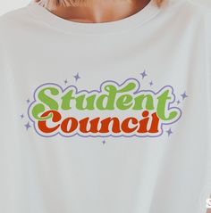 a woman wearing a white t - shirt with the words student council printed on it