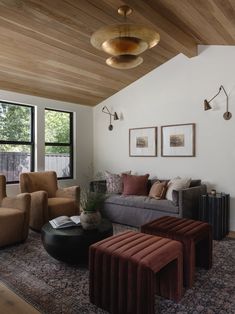 a living room filled with lots of furniture and decor on top of a wooden floor