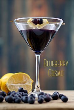 the blueberry cosmo cocktail is garnished with lemons and blackberries