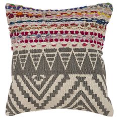 a multicolored pillow with different patterns on the front and back, sitting on a white background