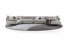 a large sectional couch sitting on top of a carpeted floor in front of a white wall