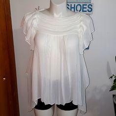 Blouse Is Brand New Never Worn. Ivory In Color And Sz. Xs. Very Flowy And Ruffled. Chic Off-white Short Sleeve Blouse, Chic Off White Short Sleeve Blouse, Summer Off White Ruffled Blouse, Cream Flowy Short Sleeve Tops, Flowy Cream Short Sleeve Tops, Flowy White Blouse With Short Sleeves, Elegant Off White Short Sleeve Top, Cream Flowy Feminine Top, Cream Flowy Ruffled Top