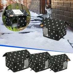 four black dog houses with paws and bones on them in front of a brick building