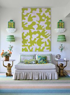 a bedroom with green and white decor on the wall