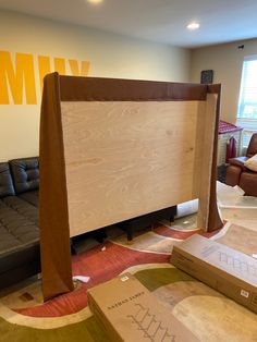 a living room filled with furniture next to a couch and wooden board on the floor