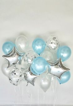 a bunch of balloons that are in the shape of stars and dots on a white background