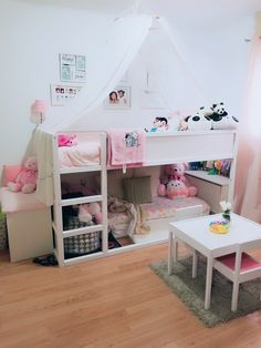 a child's bedroom with bunk beds and pink accessories on the floor, along with other children's furniture