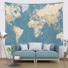 a living room with a blue couch and a large map on the wall above it