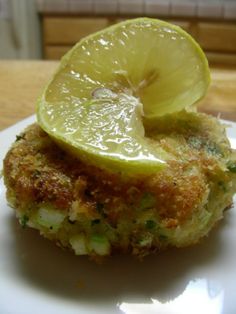 a close up of food on a plate with a slice of lemon in the middle