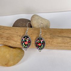 These dark floral drop earrings are colorful and fun. Dark floral vibes with silver accents. Floral Print Drop Earrings As Gift, Black Dangle Flower Earrings With Ear Wire, Handmade Black Drop Flower Earrings, Black Flower Drop Earrings For Gift, Handmade Black Drop Earrings, Multicolor Floral Print Drop Earrings, Bohemian Drop Earrings With Floral Print, Bohemian Black Dangle Flower Earrings, Black Bohemian Dangle Flower Earrings