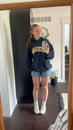 cute jorts outfit jorts slick ponytail michigan hoodie u of m hoodie white vans cute phone case outfit inso outfit inspiration gold hoops Sweatshirt And Jean Shorts Outfit, Denim Shorts And Hoodie Outfit, Shorts Outfits For School Casual, First Day Of School Outfit Highschool Summer, Hoodie With Jorts, Short Sleeve Outfit Ideas, Shorts And A Hoodie Outfit, Hoodies And Shorts