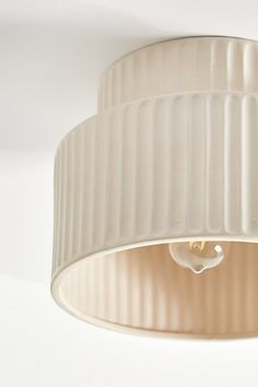 a white light fixture hanging from the ceiling