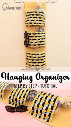 the hanging organizer is made out of cardboard and has sunglasses on it, along with other items