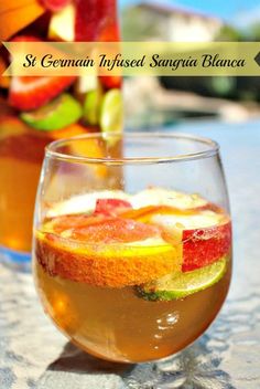 two glasses filled with liquid sitting on top of a table next to fruit and vegetables