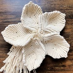 a large white flower on top of a wooden table