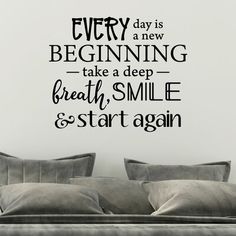 a living room wall decal that says every day is a new beginning take a deep breath smile and start again