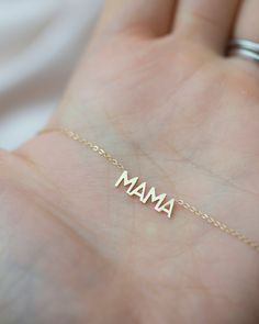 In celebration of all the great mothers around the world, treat the mom in your life to this piece of jewelry they deserve with this gold mama necklace. A perfect way to express what means most to you! Available in 14K yellow, rose or white gold Letters measure about 5mm in height Necklace total length is measured from end to end Dainty minimalist everyday necklace Personalized 14k Gold Filled Necklace For Mom, Everyday Pendant Charm Necklace For Mother's Day, Mother's Day Pendant Charm Necklace, Everyday Pendant Charm Necklaces For Mother's Day, Dainty Name Charm Necklace As Gift, Meaningful Gold Everyday Jewelry, Dainty Everyday Charm Necklaces For Mother's Day, Dainty 14k Gold Name Necklace For Mom, Everyday 14k Gold Necklace For Mother's Day