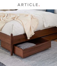 a bed with an open drawer underneath it and the words article above it that reads