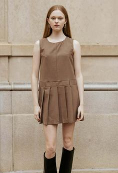 One size. fits xs-m  color: brown  jumper style mini dress  can be worn on top of a blouse  pleated bottom  belt loops at waist  invisible zipper down back center  100% polyester  dry clean  by the nkc store    product measurements:  bust: 116.84cm / 46in  length: 81.28cm / 32in    model is 177cm / 5'10" wearing size o/s Brown Jumper, Jumper Style, Mary Jane Heels, Dress Store, School Uniforms, Bandeau Top, Inner Child, Jumper Dress, Invisible Zipper