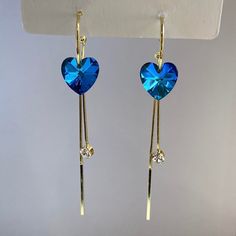 Add a touch of elegance and romance to your outfit with our Women's Blue Crystal Love Heart Earrings. These stunning dangle drop earrings feature sparkling blue crystals that exude love and beauty. Perfect for any special occasion or to add a pop of color to your everyday look. Material: Alloy/Sterling Silver Needle Earrings Size: 3.4"x0.5" Elegant Blue Earrings For Valentine's Day, Valentine's Day Blue Heart Earrings, Blue Earrings For Anniversary On Valentine's Day, Blue Elegant Heart Earrings For Pierced Ears, Elegant Blue Heart Earrings For Pierced Ears, Blue Heart Earrings For Party, Elegant Blue Heart Drop Earrings, Blue Heart Cut Earrings For Valentine's Day, Blue Heart-shaped Earrings For Party