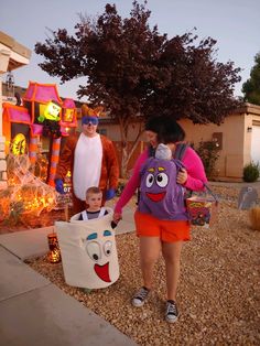 two adults and a child dressed up in costumes