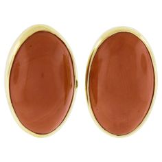 --Stone(s):-- (2) Natural Genuine Corals - Oval Cabochon Cut - Bezel Set - Reddish Orange Color - 28.94ctw (exact, certified) ** See Certification Details Below for Complete Info ** Material: Solid 18k Yellow Gold Weight: 11.58 Grams Backing: Posts w/ Omega Closures (Pierced ears are required.) Length: 23.5mm (0.92") Width: 15.4mm (0.60") Thickness: 8.9mm (at the coral) projection off the ear Condition: Vintage stones. New earrings. Comes with the original GIA certification for both of the coral Luxury Yellow Gold Oval Cabochons, Luxury Gold Oval Cabochons, Elegant Red Cabochon Gemstones, Oval Cabochons For Formal Wear Fine Jewelry, Luxury Oval Cabochon Gemstone Earrings, Oval Yellow Gold Cabochons For Formal Events, Formal Clip-on Earrings With Oval Cabochon, Classic Oval Gemstone Cabochons, Classic Oval Gemstone Earrings