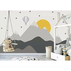 a child's room with mountains and hot air balloons on the wall, including a swing