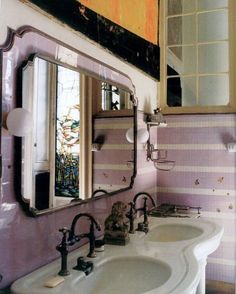 a bathroom with two sinks and a large mirror above the sink is decorated in pastel colors